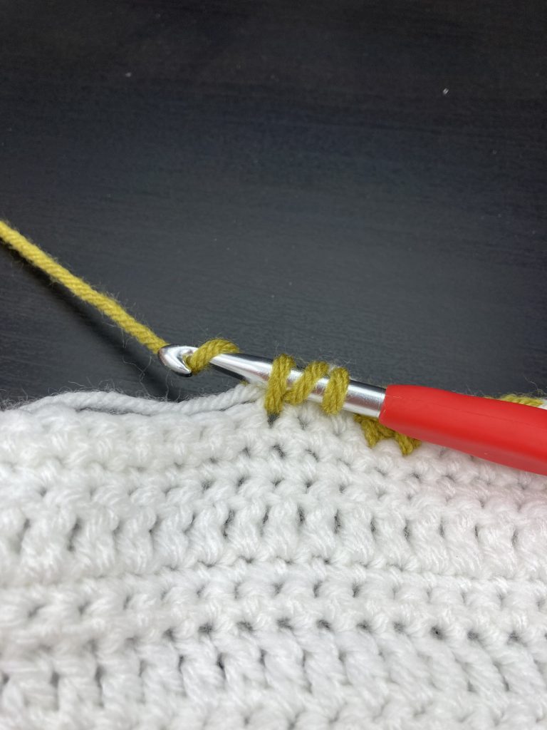 Working the first stitch of the carrot top